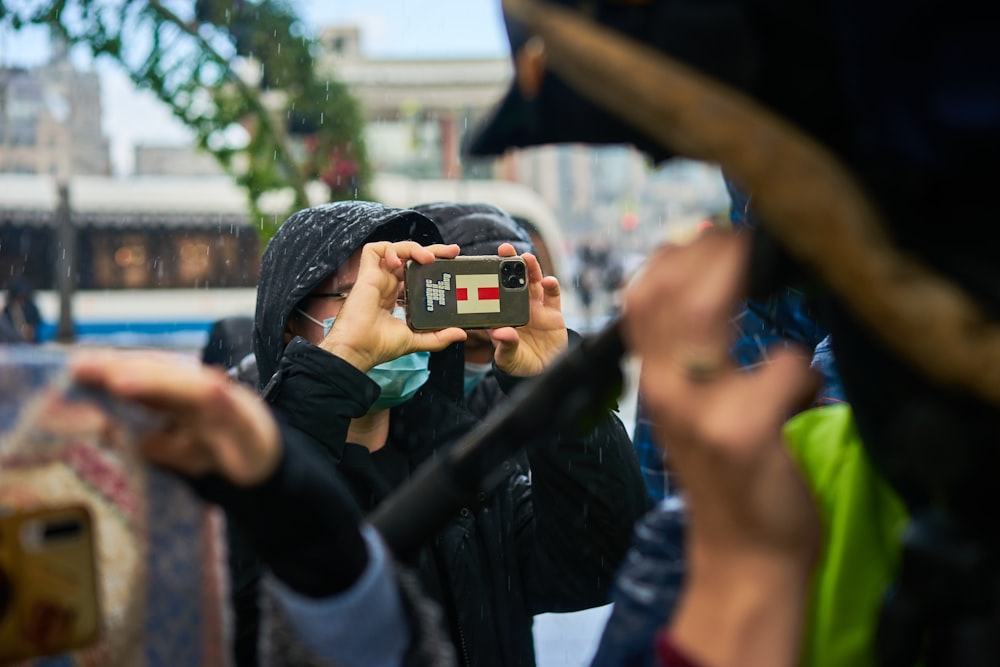 a woman taking a picture of herself with her cell phone