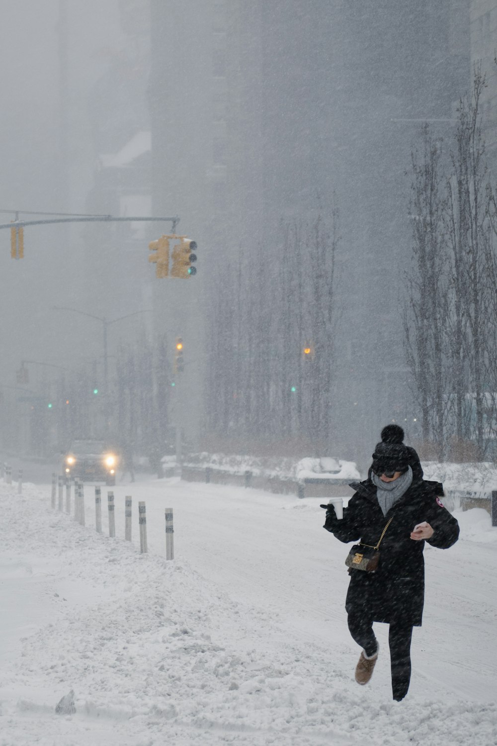 a person running through the snow in a city