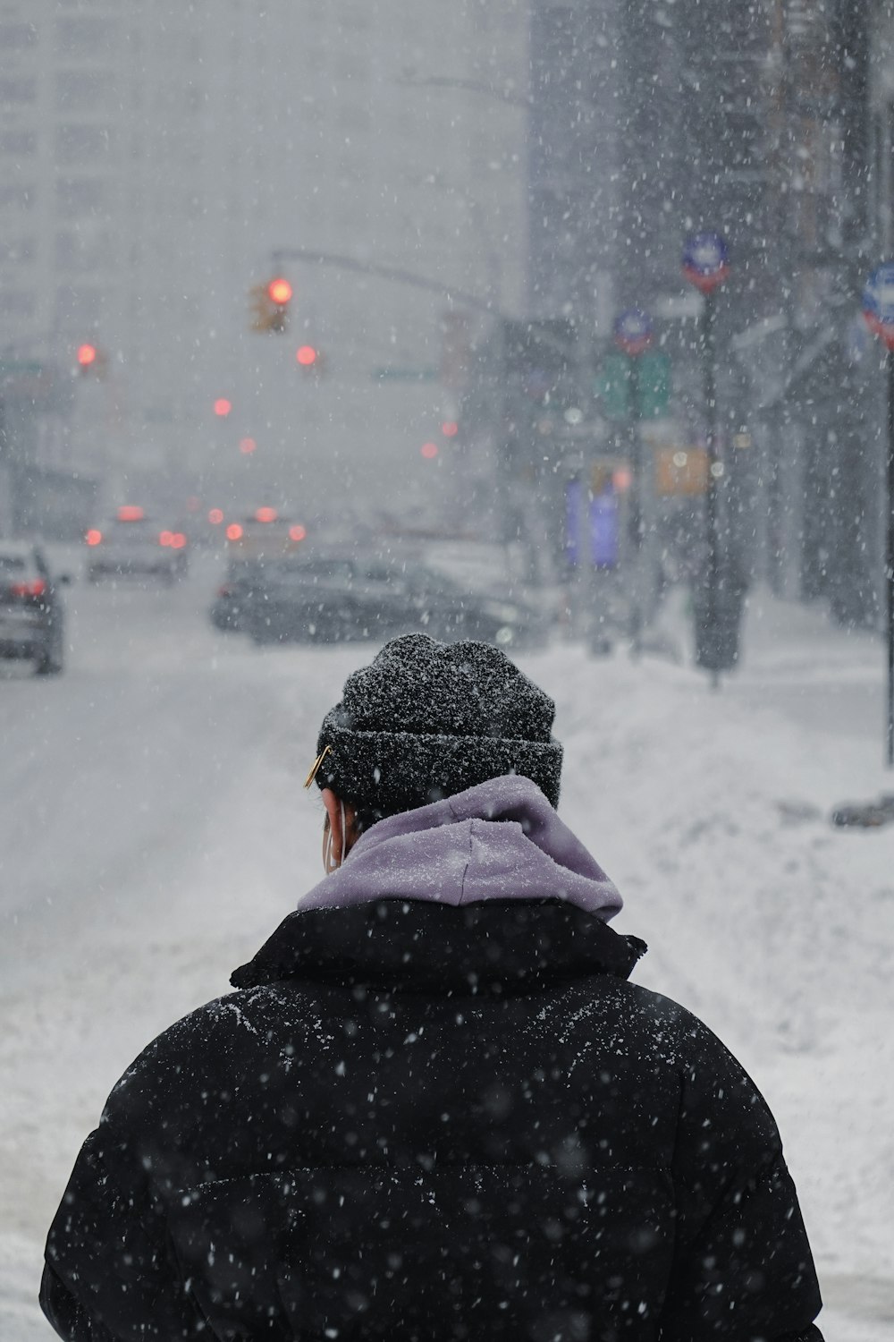 a person walking down a street in the snow