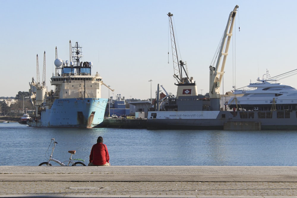 a person sitting on a bench near a body of water