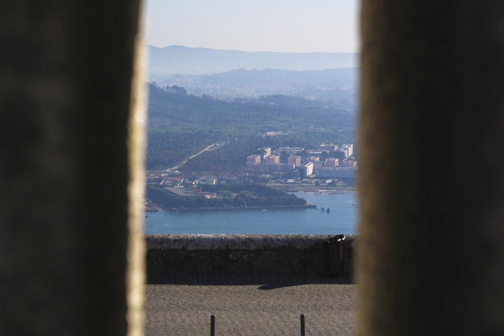 a view of a city from behind a stone wall