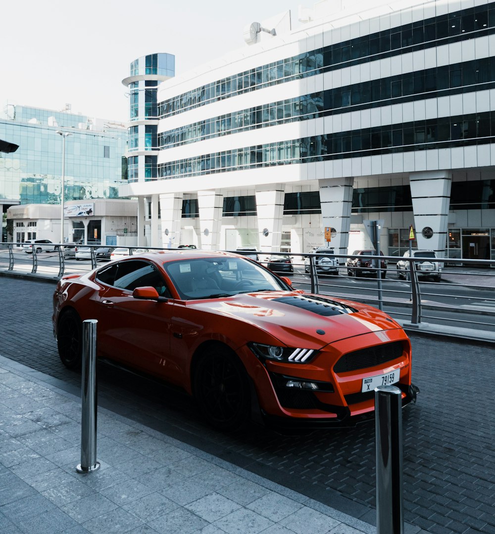 a red sports car parked in front of a building