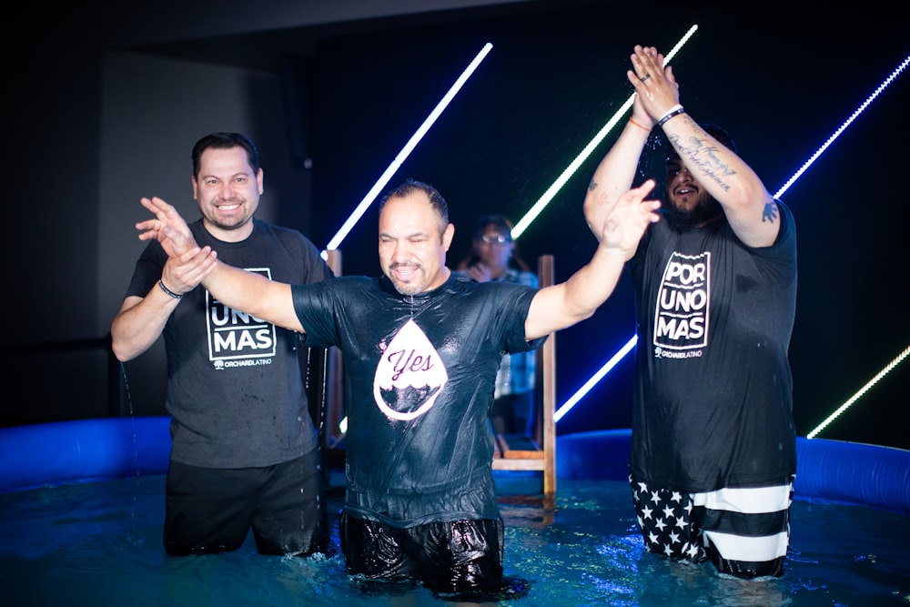 a group of men standing in a pool of water