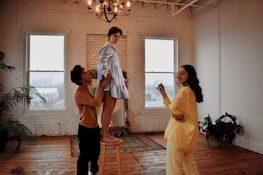 Smiling RapidRestore team member assisting a homeowner in a damaged living room.