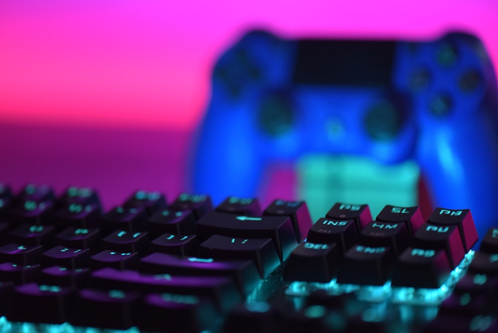 a close up of a keyboard and a video game controller