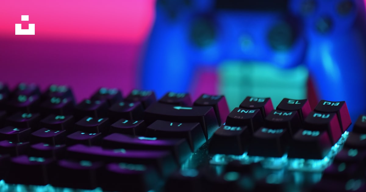 A close up of a keyboard and a video game controller photo – Free ...