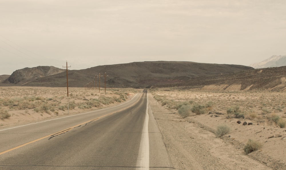 an empty road in the middle of the desert