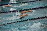 Group of students of different ages practicing swimming strokes in a lane