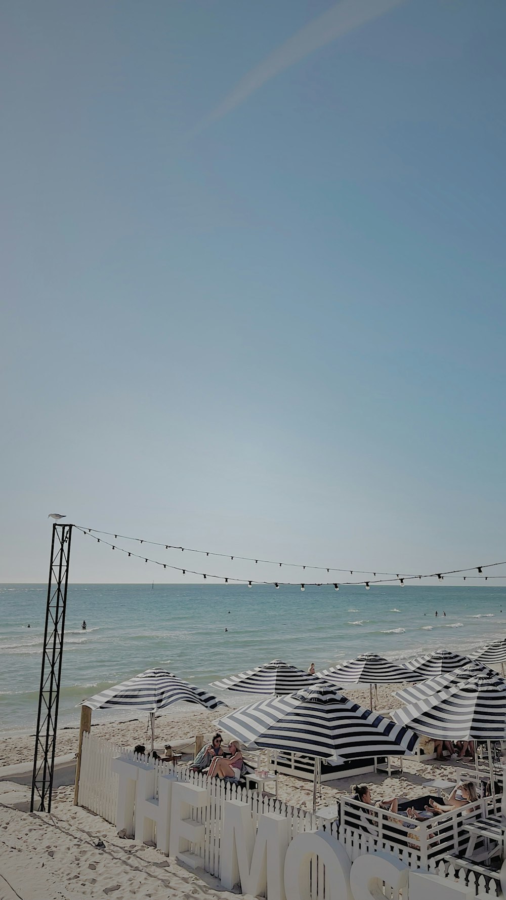 a row of beach umbrellas sitting on top of a sandy beach