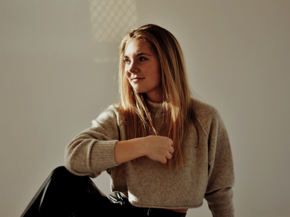 a woman sitting on the floor with her legs crossed