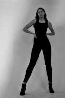 Black and white editorial shot of a model in Rusbelsoon pants and boots, standing strong.