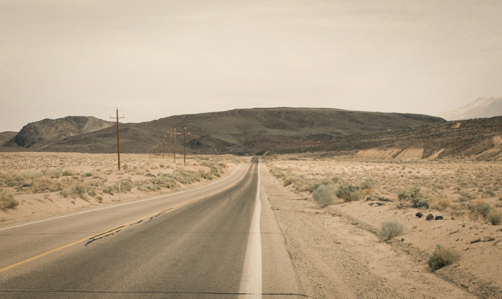 an empty road in the middle of the desert