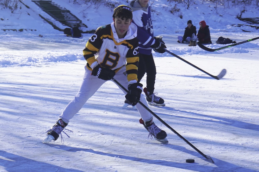 a group of people playing a game of ice hockey