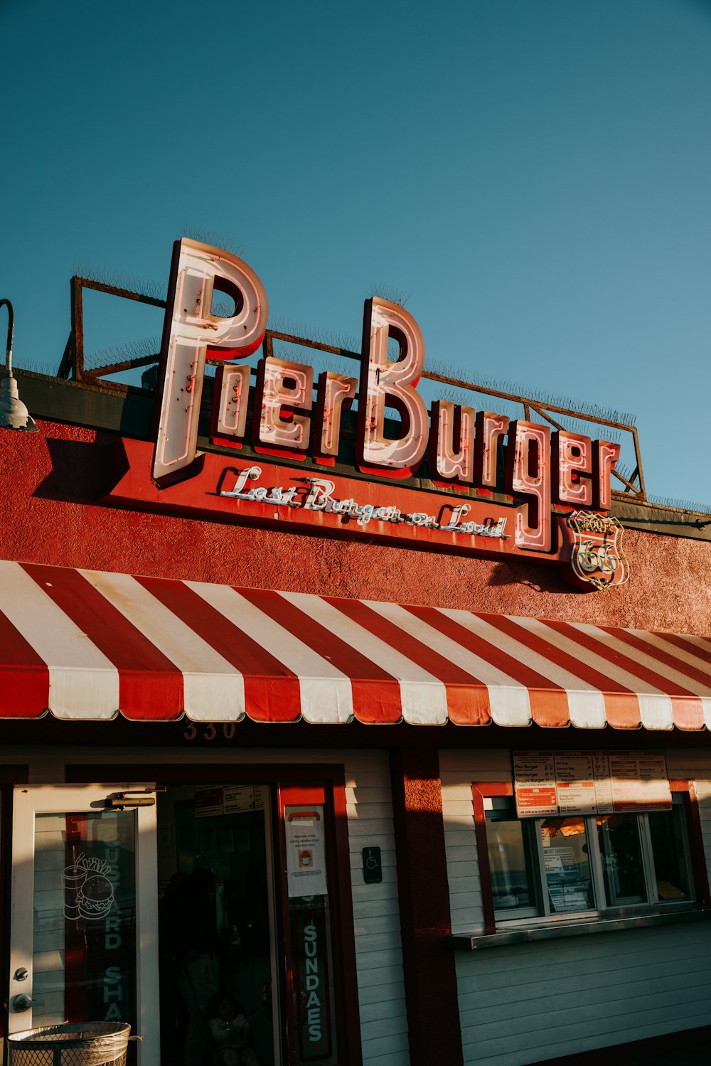 a red and white striped awning on a restaurant