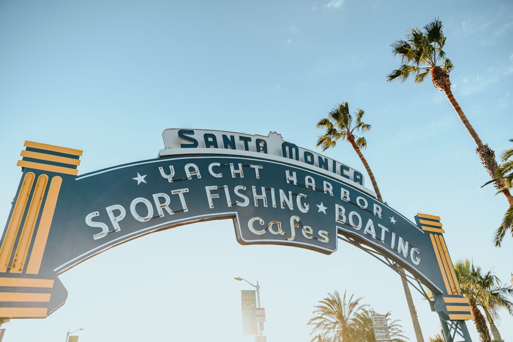 a blue and white sign that says santa monica yacht harbor sport fishing boating