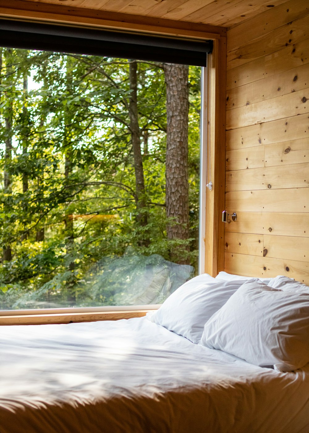 a bed in a bedroom next to a window