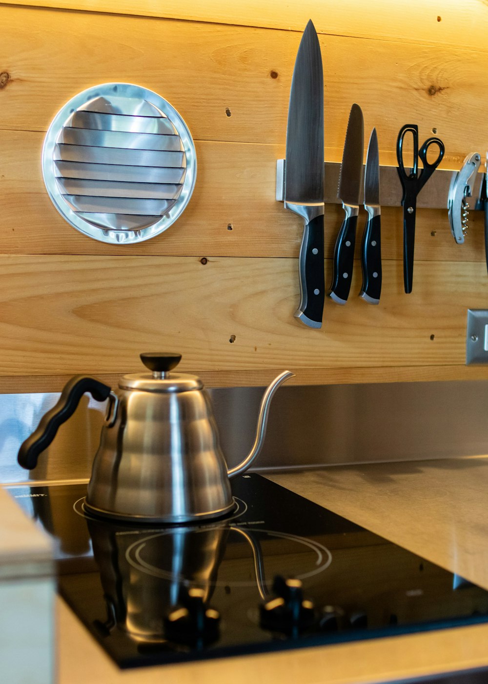 a stove top with a tea pot on top of it