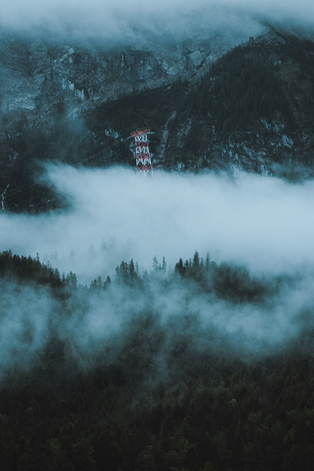 a view of a mountain covered in fog