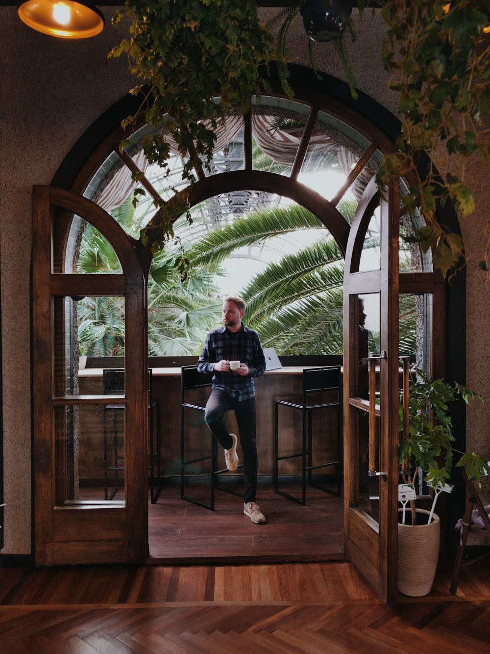 a man sitting at a table in front of a window