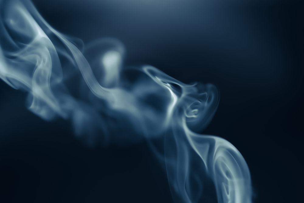 a blurry photo of smoke on a black background