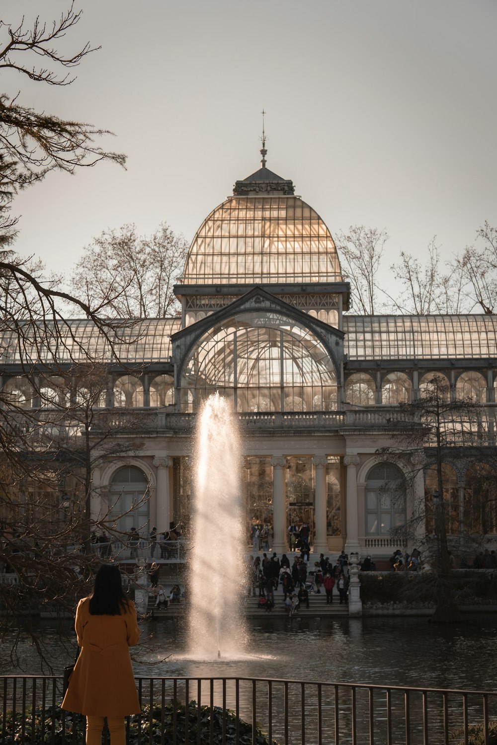 a woman standing in front of a water fountain