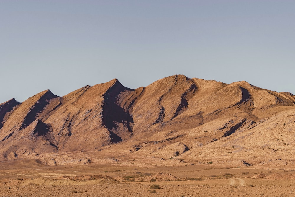 a group of mountains in the middle of a desert