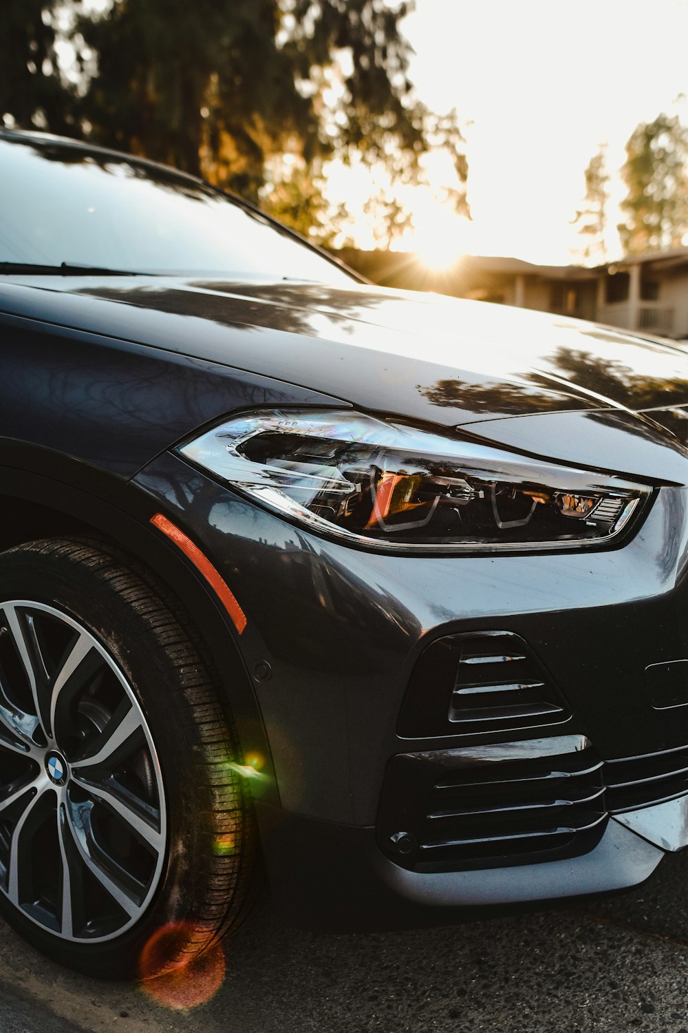 a black bmw suv parked on the side of the road