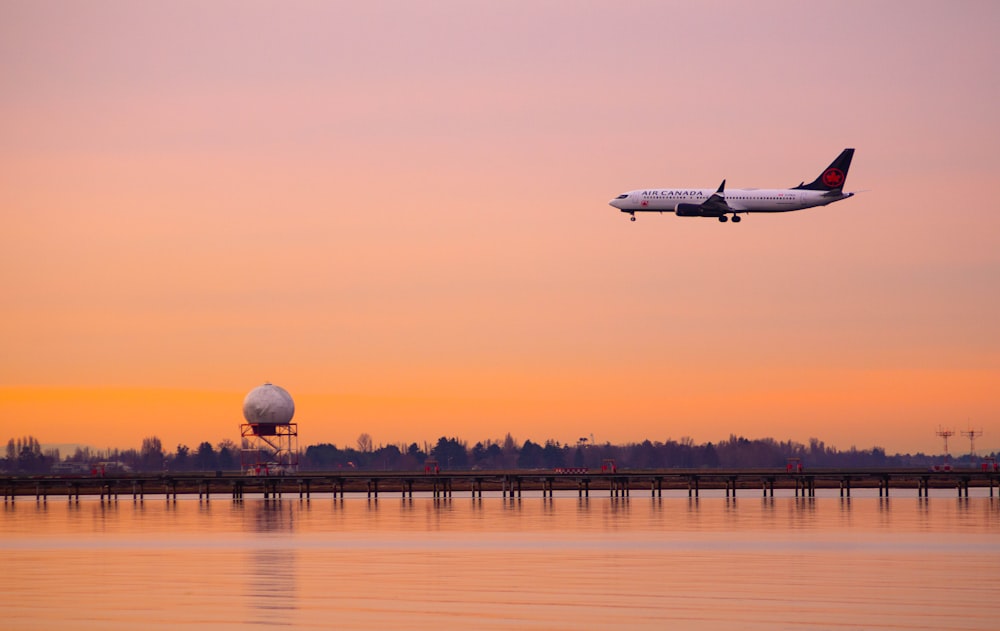 a plane is flying over a body of water