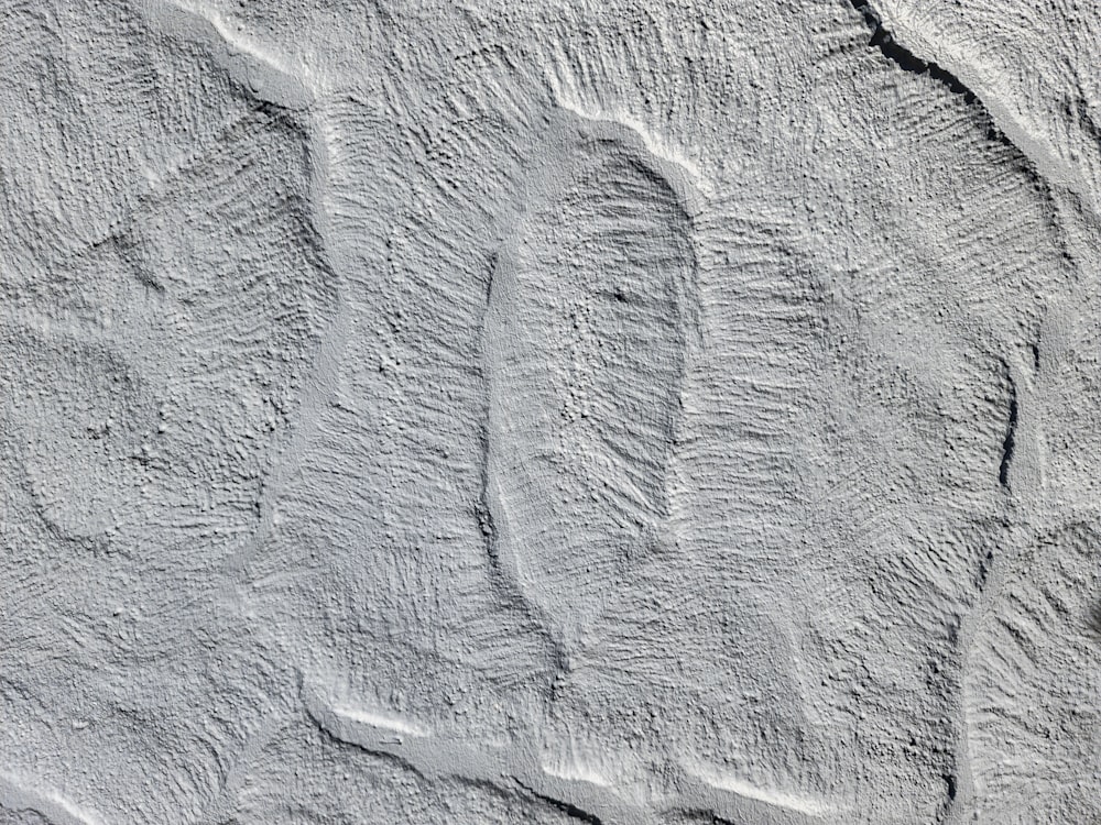 a close up of a wall with a person's foot prints on it