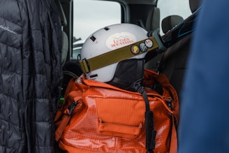 a helmet on top of a backpack in the back of a truck