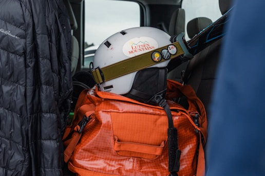 a helmet on top of a backpack in the back of a truck
