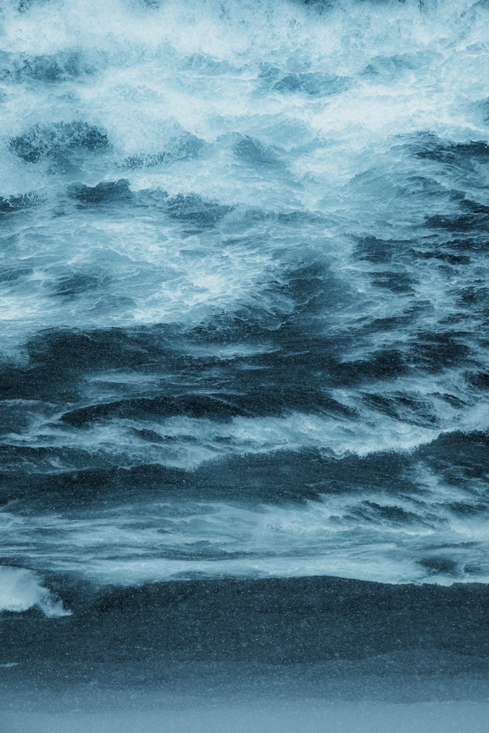 a person standing on a surfboard in the ocean