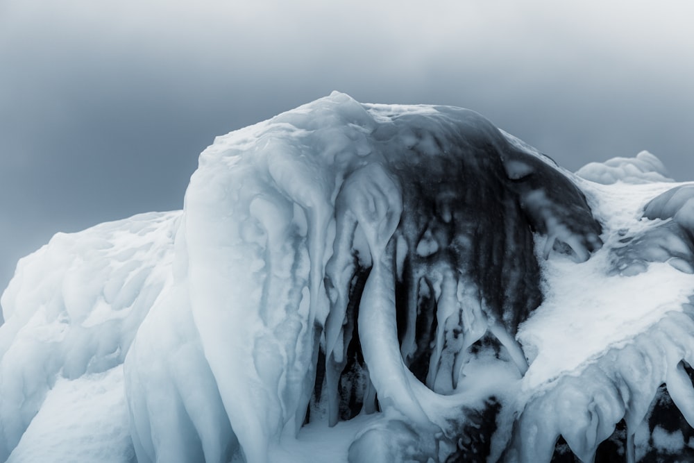 a very large ice covered rock in the snow