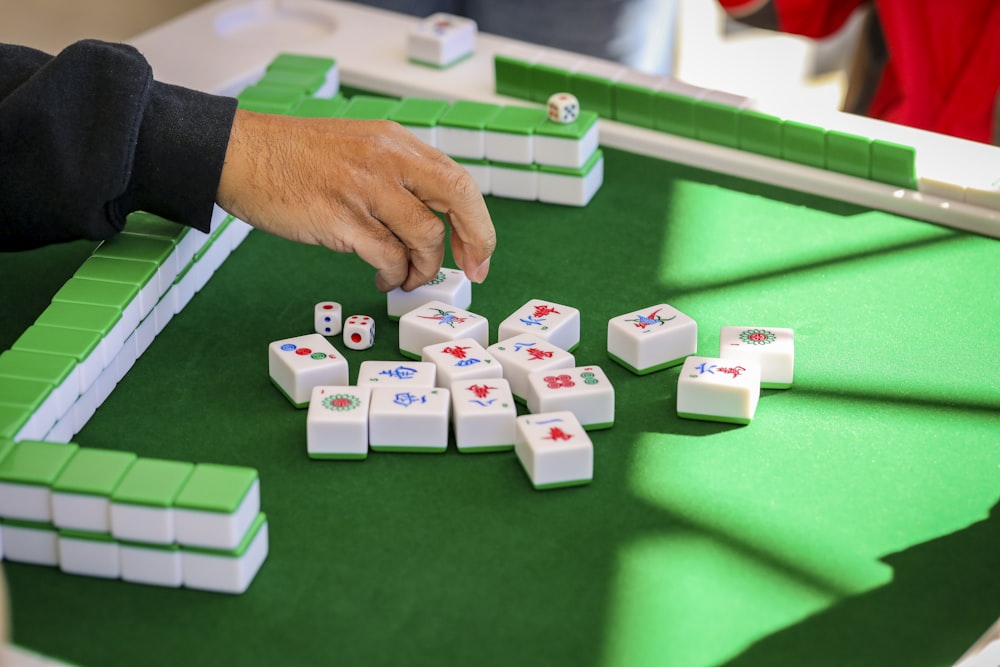 a person playing a game of dominos on a table