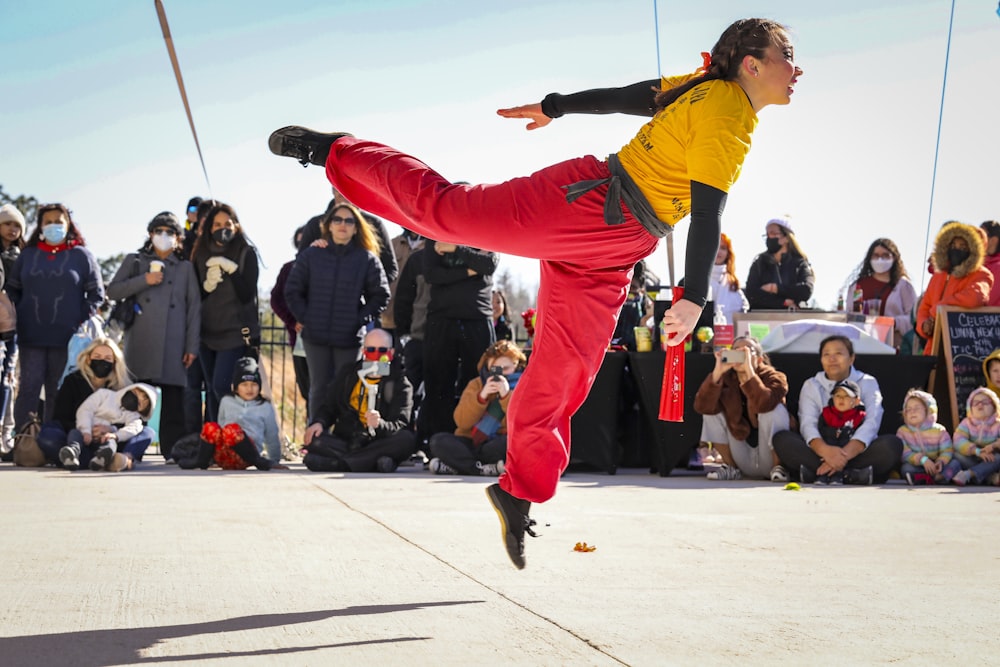 a person doing a trick on a skateboard in front of a crowd