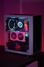 An assembled custom gaming PC with glowing components and cables neatly organized on a dark desk.