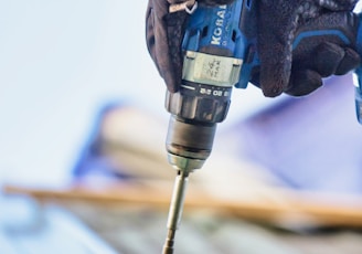 a person using a drill to drill a piece of wood