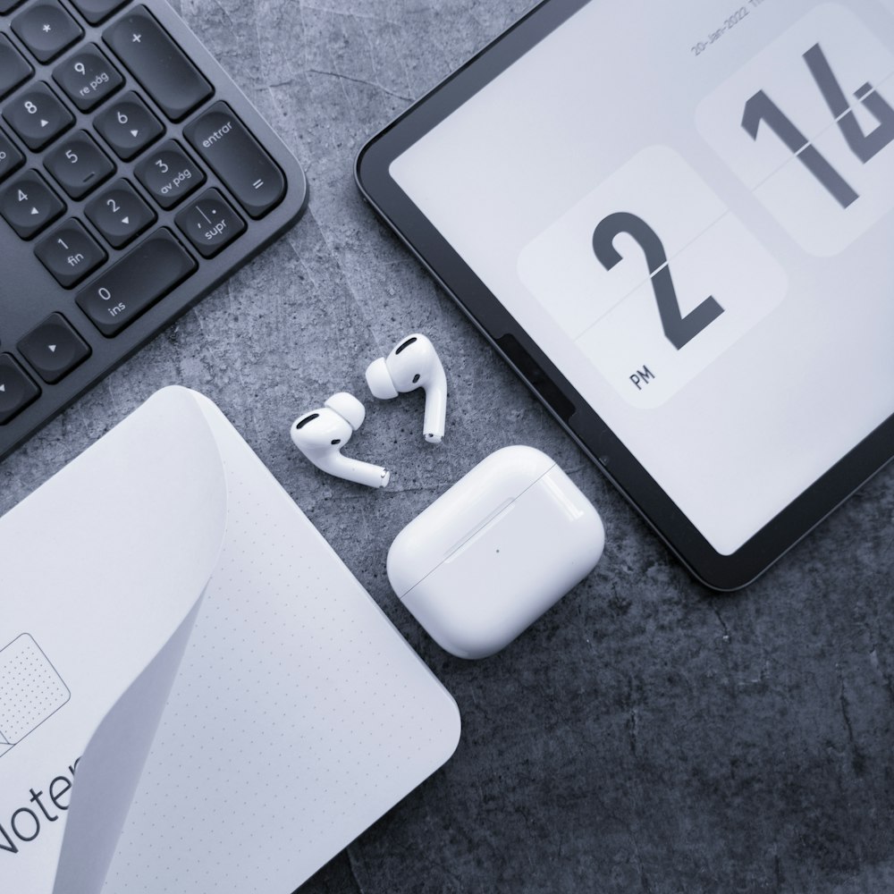 a pair of headphones sitting next to a tablet