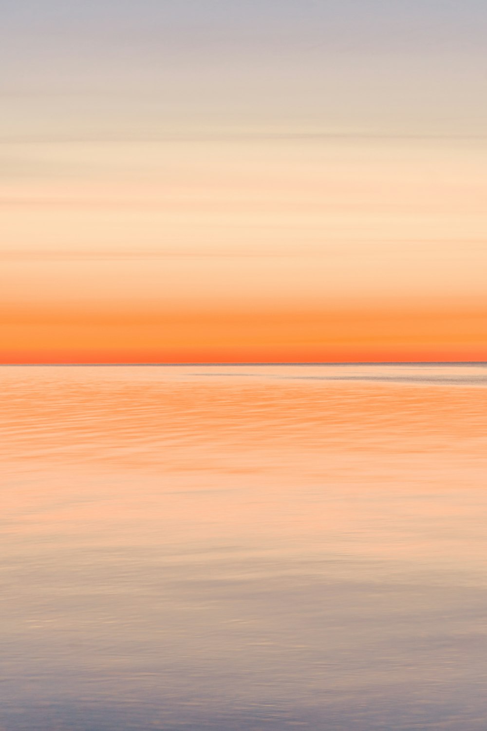 a large body of water with a boat in the distance