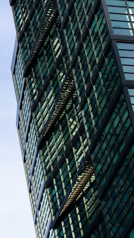 Modern architectural office building exterior with sleek black and green accents.