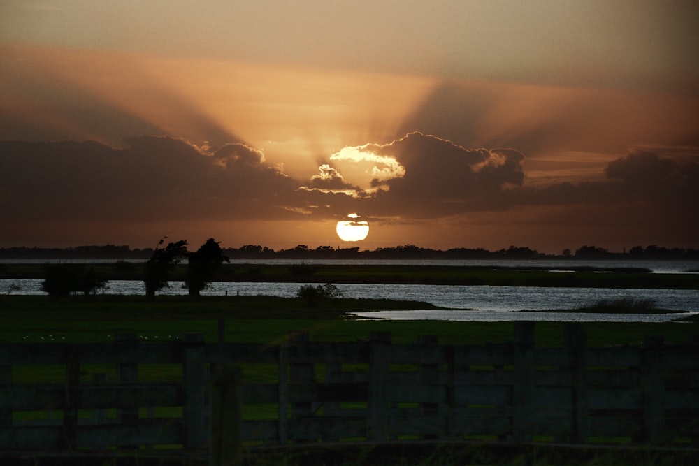 the sun is setting over a body of water