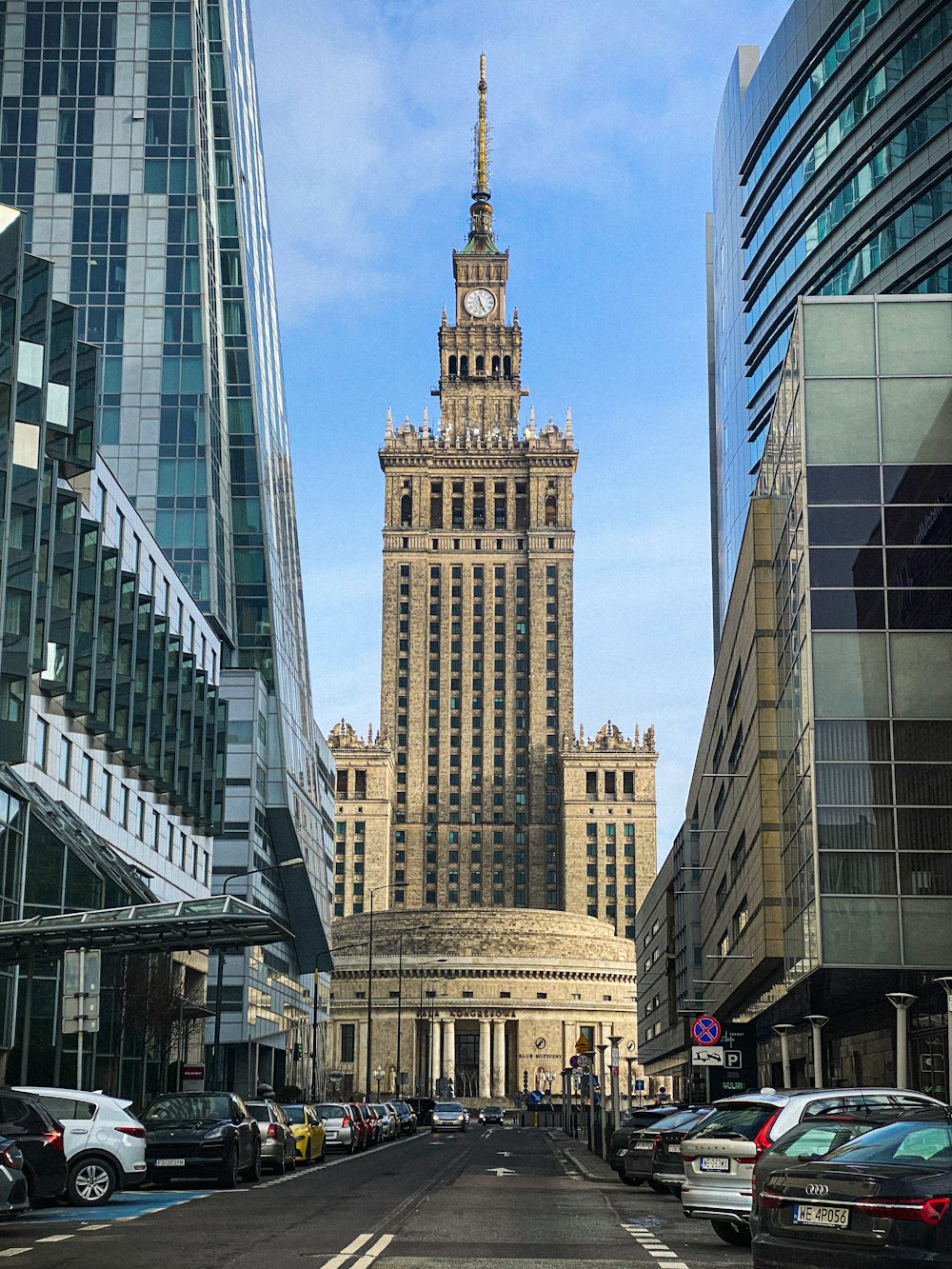 a very tall building with a clock tower in the middle of a city