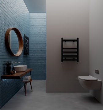 A crisp, fresh bathroom featuring large white tiles, warm wooden shelves, and soft blue lighting ambiance.