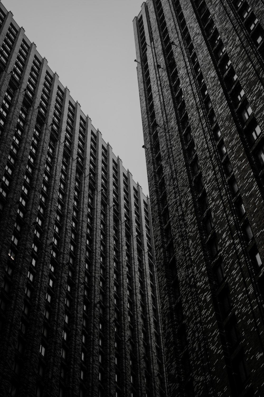 a black and white photo of tall buildings