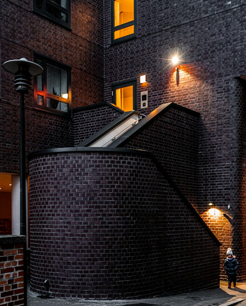 a person standing in front of a building at night