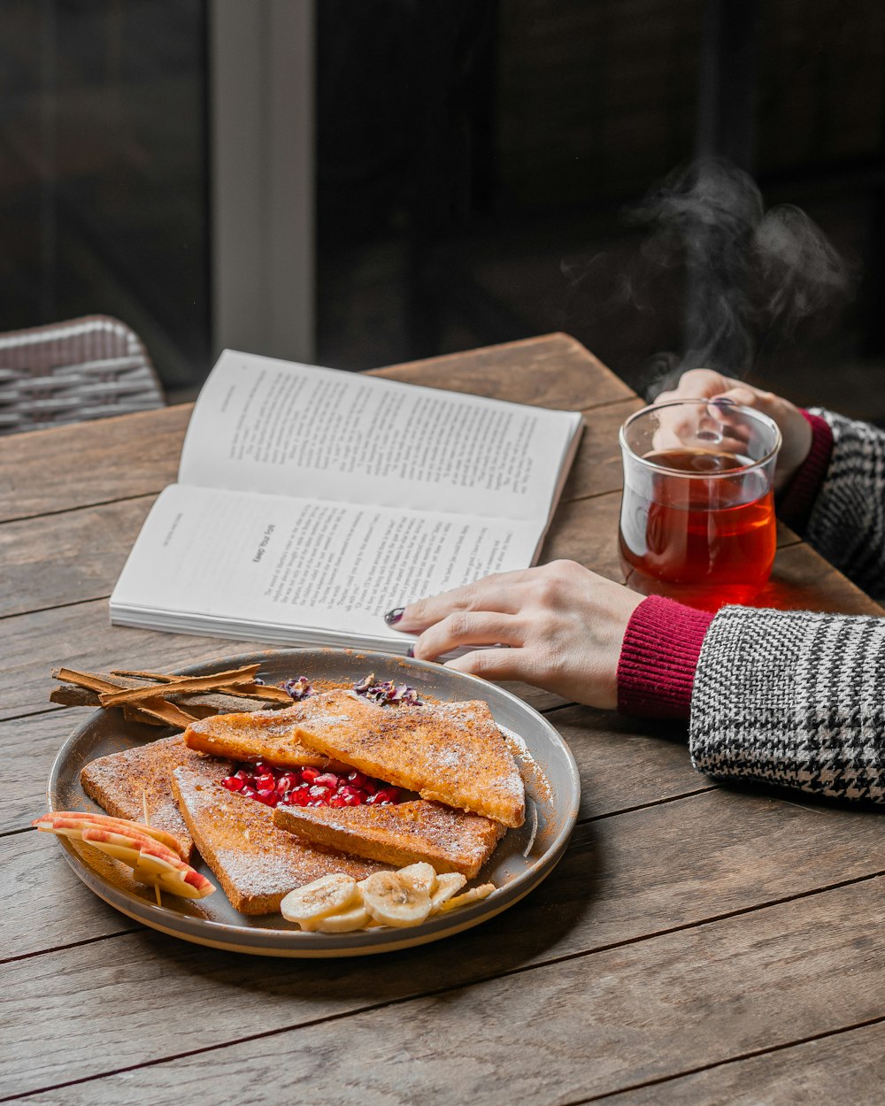 a person sitting at a table with a plate of food