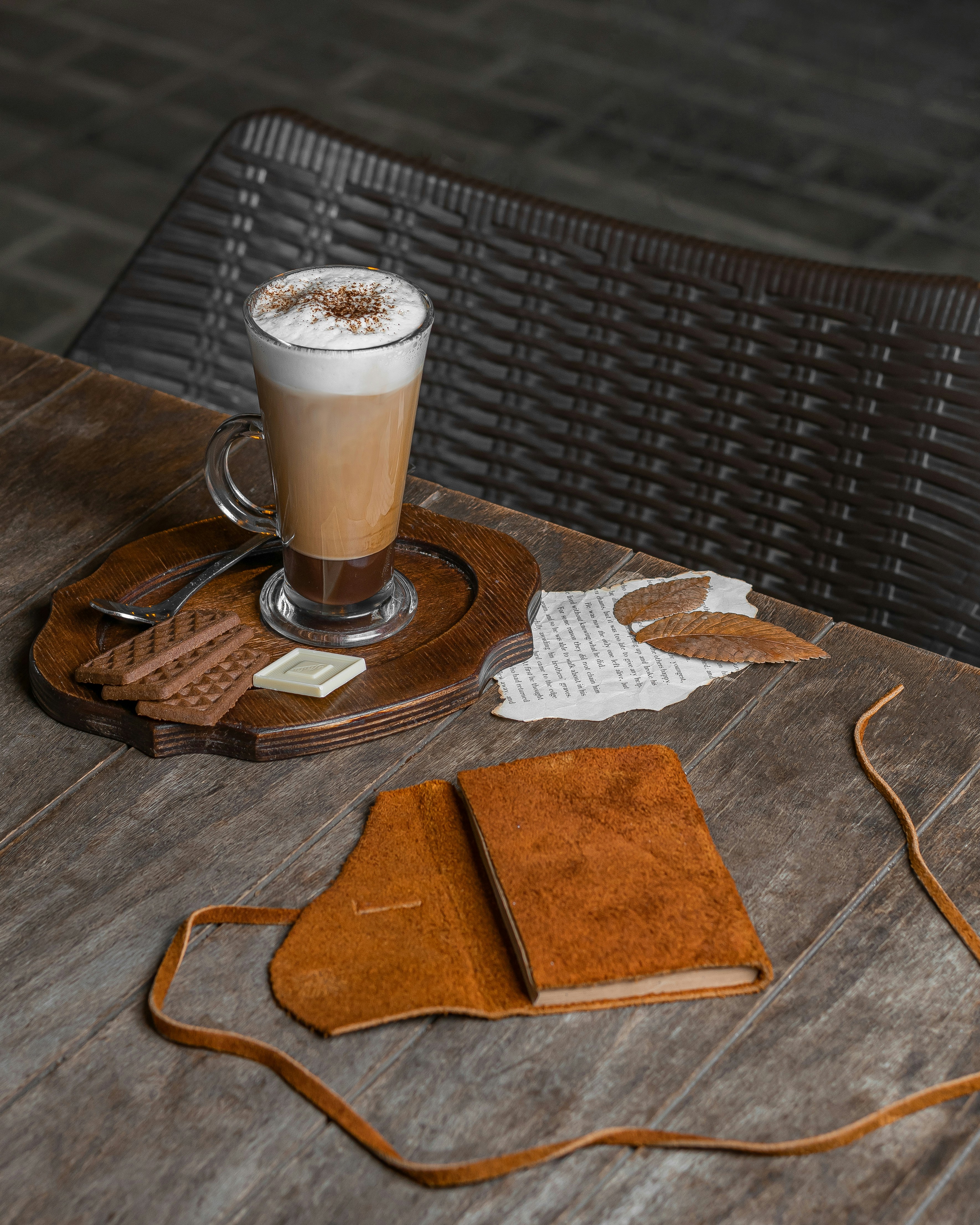 a cup of coffee sitting on top of a wooden table