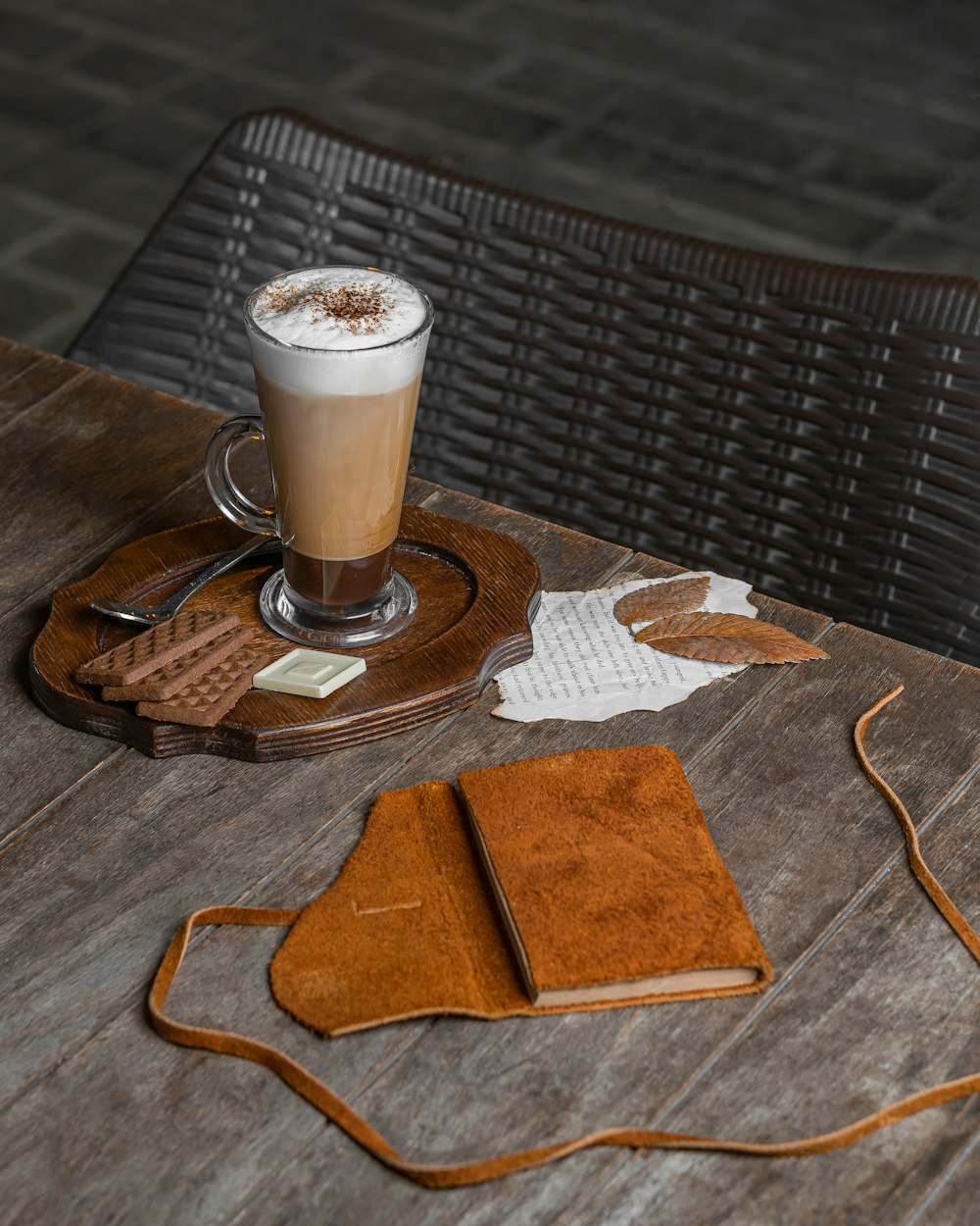 a cup of coffee sitting on top of a wooden table