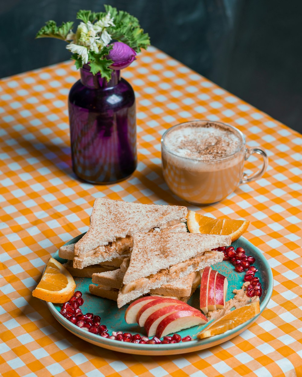 a plate of food on a table next to a cup of coffee