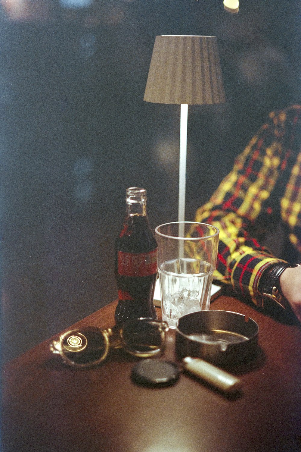 a person sitting at a table with a bottle of alcohol